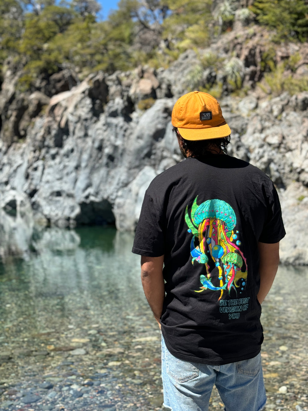 Altiplano Jellyfish Drift tee worn at a turquoise Andean lake
